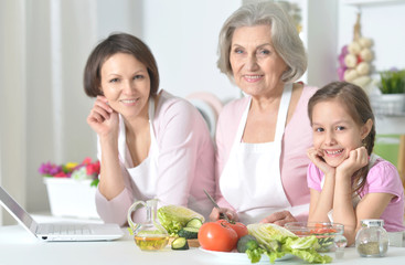 Mother, daughter and grandmother cooking together 