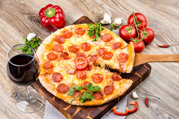 Photo of a hot pizza on wooden background