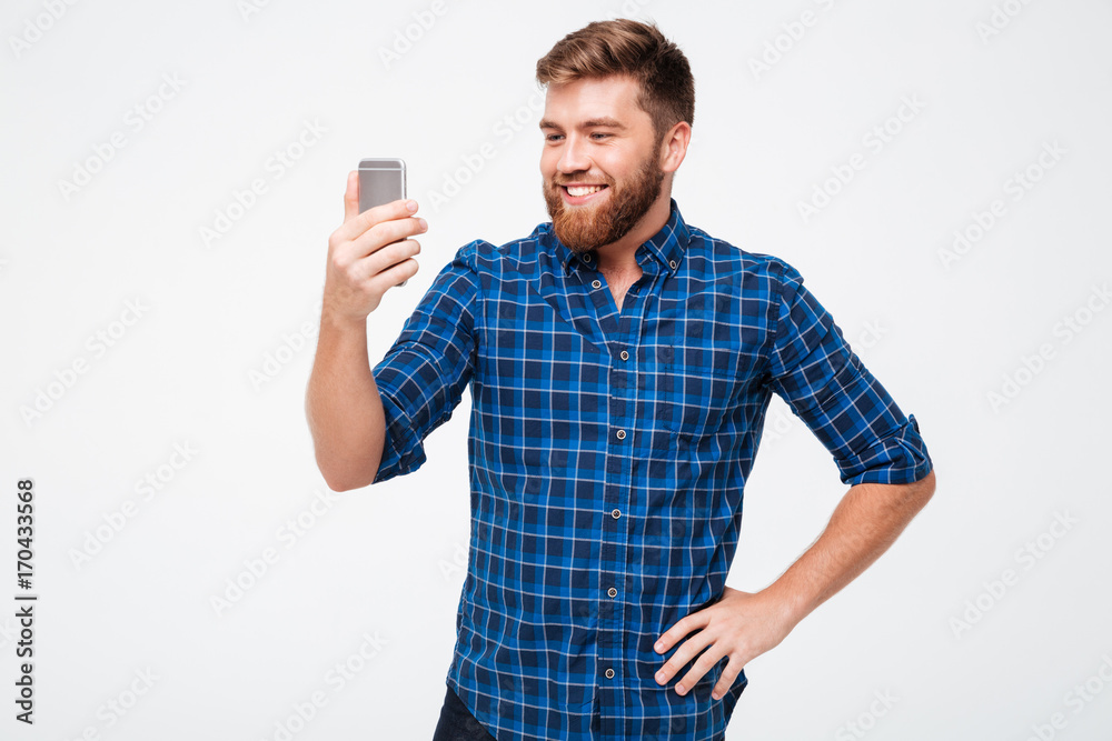 Sticker picture of smiling bearded man in checkered shirt