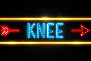 Knee  - fluorescent Neon Sign on brickwall Front view