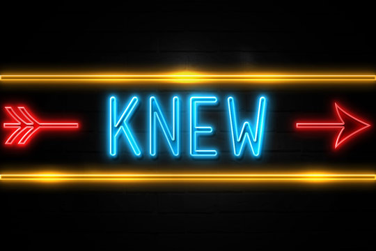 Knew  - fluorescent Neon Sign on brickwall Front view