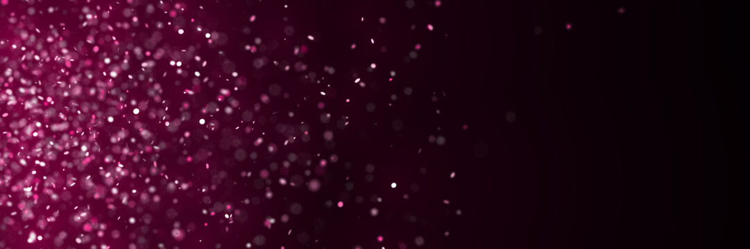 sparkling glitter in shades of pink and purple in front of a dark background (banner)