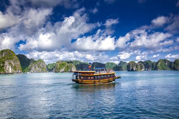 cruising among beautiful limestone rocks and secluded beaches in Ha Long bay, UNESCO world heritage site, Vietnam