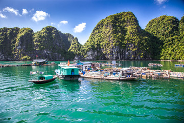 cruising among beautiful limestone rocks and secluded beaches in Ha Long bay, UNESCO world heritage site, Vietnam