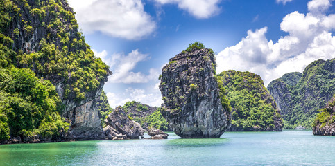 cruising among beautiful limestone rocks and secluded beaches in Ha Long bay, UNESCO world heritage site, Vietnam
