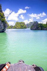 cruising among beautiful limestone rocks and secluded beaches in Ha Long bay, UNESCO world heritage site, Vietnam