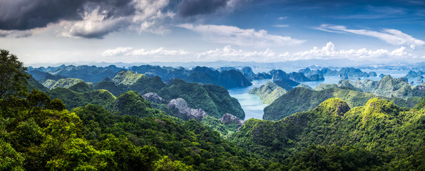 scenic view over Ha Long bay from Cat Ba island, Ha Long city in the background, UNESCO world heritage site, Vietnam - obrazy, fototapety, plakaty