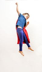 dynamic isolated super hero boy jumping high, flying over white