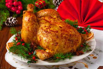Roasted whole chicken with Christmas decoration.