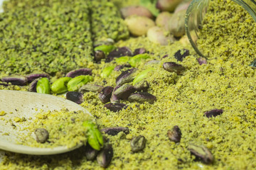 Green pistachio cookie of Bronte with wooden spoon and glasses