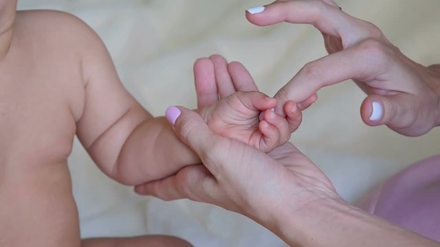 Mom Stroking a baby's hand
