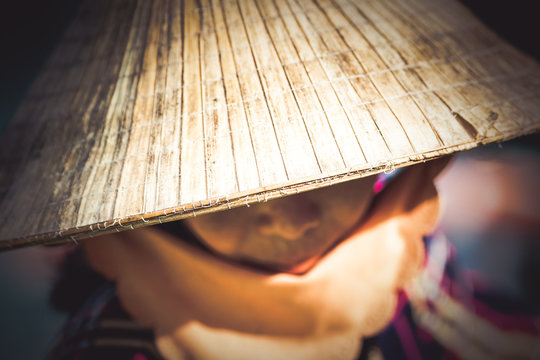 woman wearing traditonal vietnamese hat