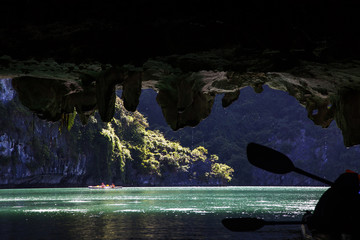 kayaking among caves and lagoon in Ha Long bay, UNESCO world heritage site, Vietnam