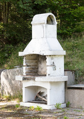 Old white barbeque in the Alps