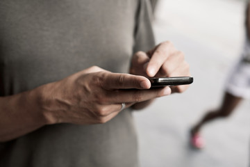 young man using a smartphone in the street