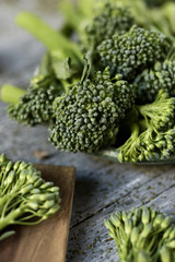 stems of raw broccolini on a rustic table