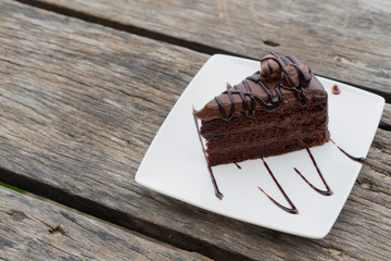 piece chocolate cake work path white plate wooden table
