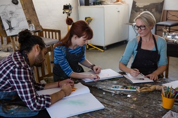 High angle view of adult student practicing in art class