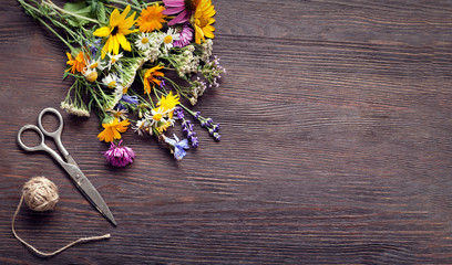 Bouquet of wild flowers scissors vintage board