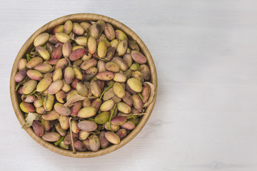 Wooden bowl with fresh pistachio of Bronte..