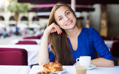 Young woman is dreaming in time breakfast