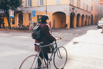 Young woman walking outdoor holding bicycle - transport, feeling free, green lifestyle concept