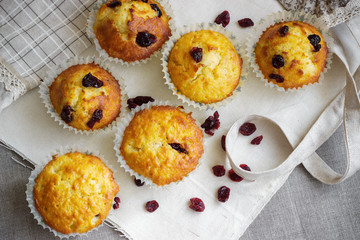 Homemade muffins with raisins on the burlap cloth