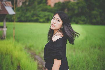  Portrait a beautiful asian woman flicking her hair at cornfield