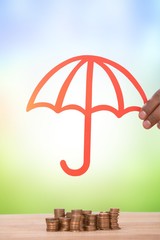 Composite image of hand holding a red umbrella