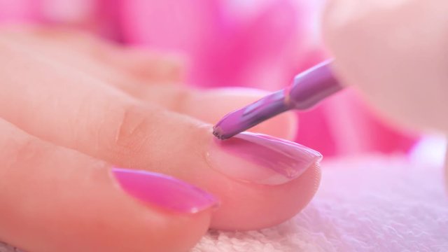 Female hands manicure close up view. Delicate purple manicure