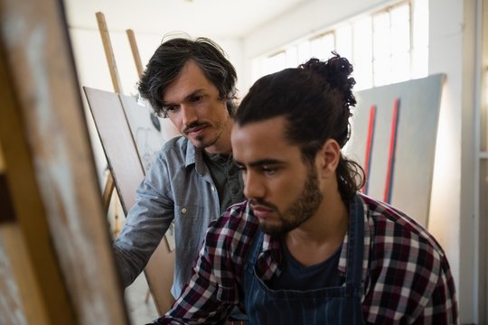 Artist Assisting Man Painting