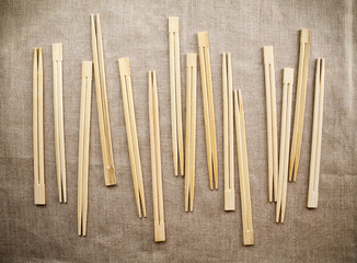 Many Asian wooden chopsticks  arranged in a row background. Lots of Chinese traditional eating utensils