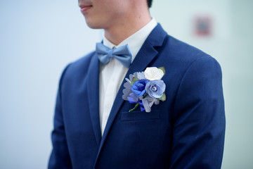 boutonniere in the pocket of the groom. colorful wedding boutonniere on suit. Blue Flower for Boutonniere.