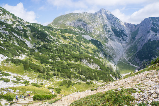 Studor pass, Julian alps, Slovenia - Avgust 18, 2012: Hikers approaching the top of the pass on the hike from Pokljuka to Vodnik mountain hut.