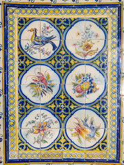 Beautiful and colorful Portuguese tiles (azulejos) with drawings of birds and plants in Lisbon, Portugal