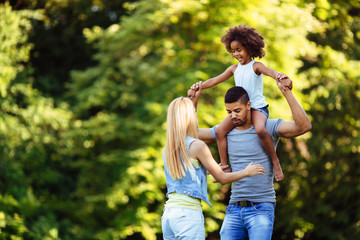 Fototapeta premium Picture of happy young couple spending time with their daughter