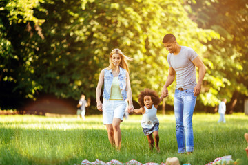 Happy young couple spending time with their daughter