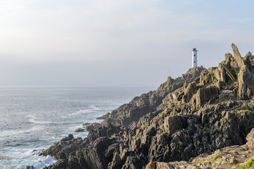 white lighthouse on the background of the ocean