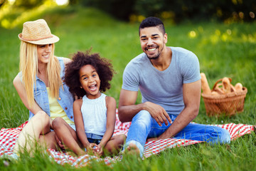 Picture of lovely couple with their daughter having picnic