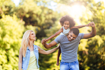Fototapeta premium Picture of happy young couple spending time with their daughter