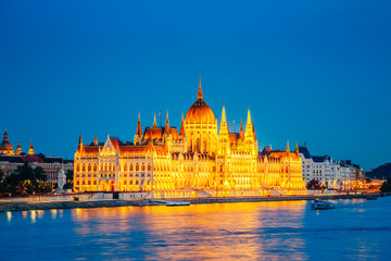 Fototapeta na wymiar Evening view of Hungarian Parliament with Margit bridge. Famous place Budapest, Hungary, Europe.