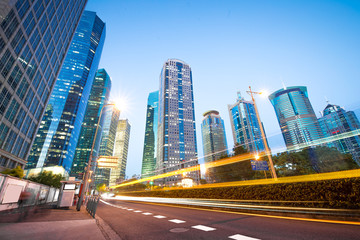 The light trails on the modern building background in shanghai china.