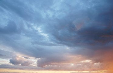 Naklejka na ściany i meble Stormy clouds in the sunset background 