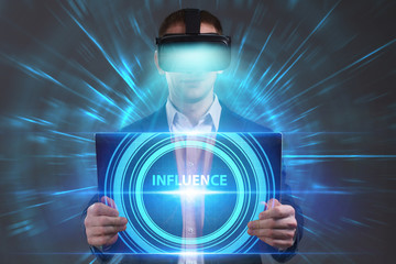 Business, Technology, Internet and network concept. Young businessman working in virtual reality glasses sees the inscription: Influence