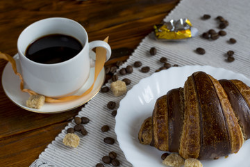 coffee and croissants on black background