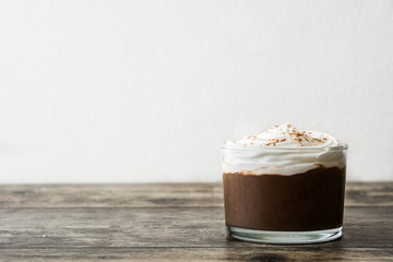 Chocolate mousse on wooden table. Copyspace.

