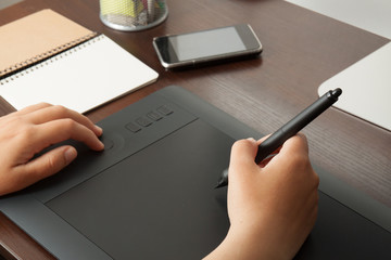 Graphic designer draws on a tablet