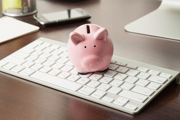 Money box pig on keyboard