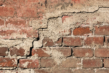 Background of the cement wall grey plain textured with a crack diagonally with elements of red brick.