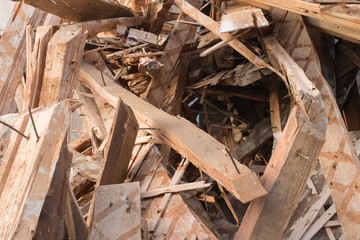 Pile of planks after renovation of building. Heap of broken boards with nails. Old boards. Repair of the building. Construction garbage